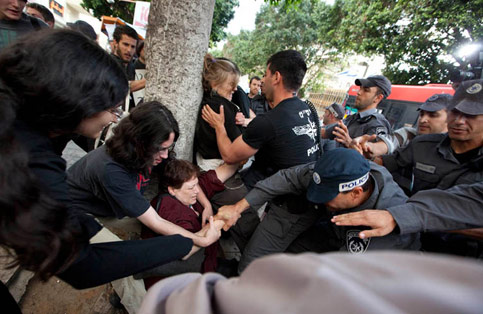  Israeli policemen beat and arrest women at a demonstration held by the feminist movement New Profile in support of six activists from the group who were arrested from their homes by the police, 30 April 2009. (Shachaf Polakow/ActiveStills)