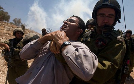 Hassan Mousa being arrested during a demonstration at the wall. (Activestills)